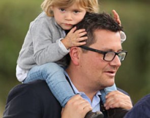 François Kasselmann carrying his child around the Verden show grounds