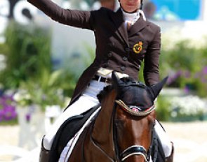 Belgian Julie de Deken waves to the crowds after finishing her ride on Lucky Dance