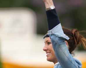 Lyndal Oatley signals to her husband Patrik in the warm-up that he has won the class
