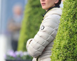 Florine Kienbaum's trainer Caro Roos watches her student's horse Doktor Schiwago in the warm-up