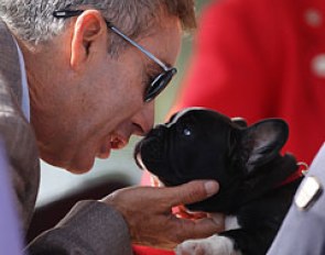 US team trainer Robert Dover snuggles with Evi Strasser's Hungarian bred French bull dog pup Maximilian