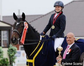 Peter Storr hands the trophy to Kristina Shvetsova, the junior rider individual test winner at the 2014 CDI-JYR Ryazan in Russia