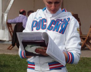 Russian rider Diana al Shaer looks at her score sheets