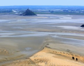 Giant 2.3m by 2.5m horse hoof prints created in the Bay of Mont-Saint-Michel, the famous UNESCO World Heritage Site, by French artist and sand sculptor Christophe Dumont, mark 100 days to the start of the 2014 World Equestrian Games