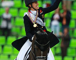 Charlotte Dujardin and Valegro in their victory lap. Charlotte is waving the British team's lucky mascot "Freddy" to the crowds. 