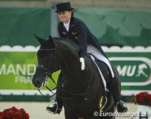 Kristina Sprehe pats her Desperados after completing the Grand Prix at the 2014 World Equestrian Games :: Photo © Astrid Appels