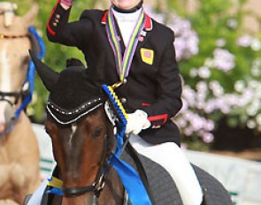 Phoebe Peters pointing the "Anky finger" at her pony SL Lucci in their lap of honour
