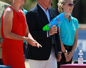 Show host Bernadette Brune and stable manager Ralf Heffenmenger are having a bit of fun during awards with a toy water gun