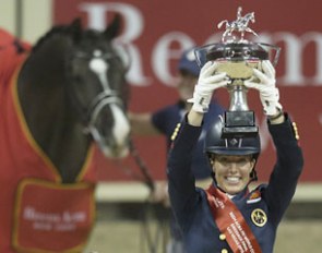 Great Britain’s Charlotte Dujardin holds the new World Cup trophy aloft after making it a back-to-back double of victories with the amazing Valegro at the 2015 World Cup Dressage Final :: Photo © Dirk Caremans