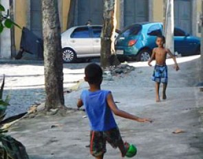 Kids playing soccer in the streets
