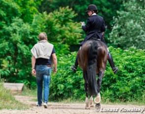 Izabela Kowalska walking back to the stable on Don Alonso, accompanied by her husband Tomasz
