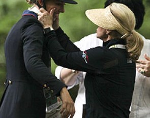 Trainer Debbie McDonald squeezes Laura Graves' cheeks after the prize giving ceremony