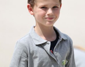 A young boy from the Rotterdam riding school picking up the test sheets after each ride
