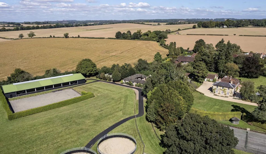 A well-appointed country house with an extensive equestrian facility including a bespoke indoor and outdoor school. 