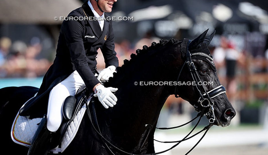 Justin Verboomen patting Zonik Plus after a winning test at the 2026 CDIO Lier :: Photo © Astrid Appels