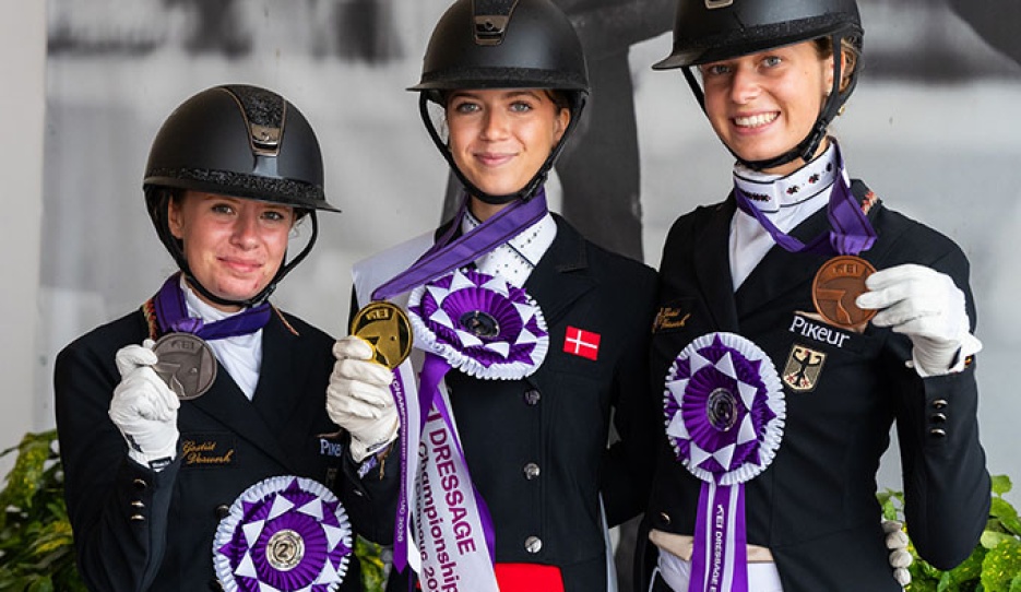 The Kur podium at the 2026 European Junior Riders Championships with Kohoutek, Asmussen, and Wagner showing their medals :: Photos © Lukasz Kowalski