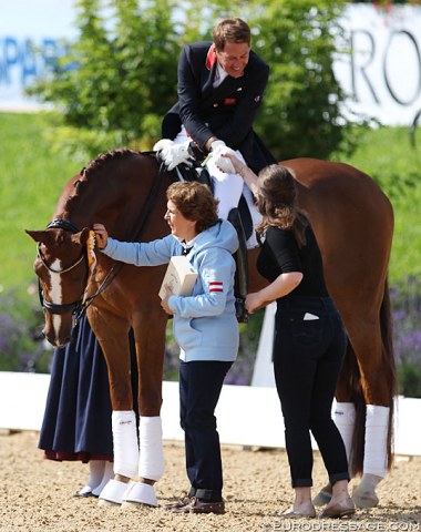 Show host Evelyn Haim-Swarovski pats Dono di Maggio as daughter Marie Haim congratulates Emile Faurie