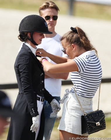 Sister Alexandra fixing Anne Sophie Sorensen's stock tie