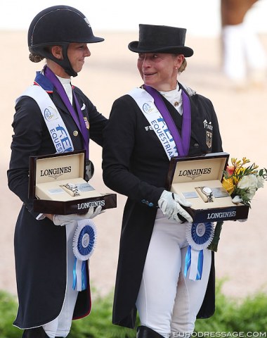 Laura Graves puts her hand on Isabell's shoulder as the gold medalist is in tears during the national anthem