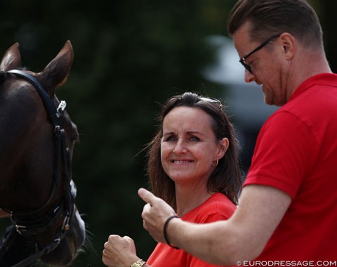 Liva Addy Guldager Nielsen's parents fist pump and celebrate as they check their daughter's scores online instantly as she comes out of the arena.