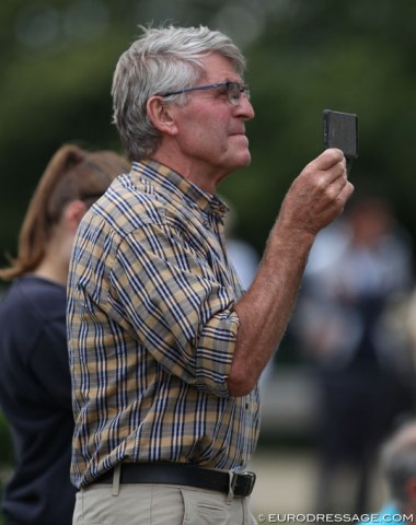 Hugo Jorissen, breeder of Ikke Pia van de Bergerhoeve, filming Lore Vandenborne's ride. The gelding is out of Pikante Pia van der Bergerhoeve, shown at international Grand prix level by Philip Jorissen