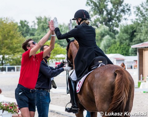 Danish team trainer Dennis Fisker high fives with Laura Jarlkvist Rasmussen on Aatoftens Dornier