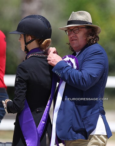 Lucie-Anouk's father Lars Baumgurtel fixing the champion's sash