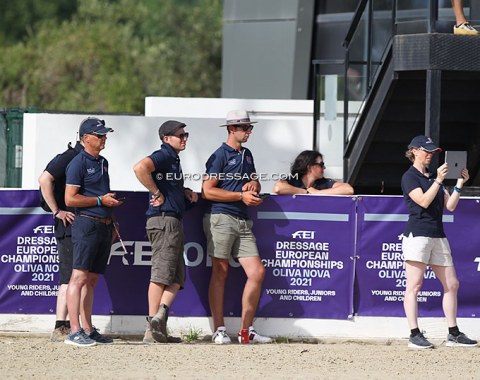 The British delegation with team trainer Clive Halsall (far left) and chef d'equipe Tom Hobday (third from left) watching Caitlin Burgess ride