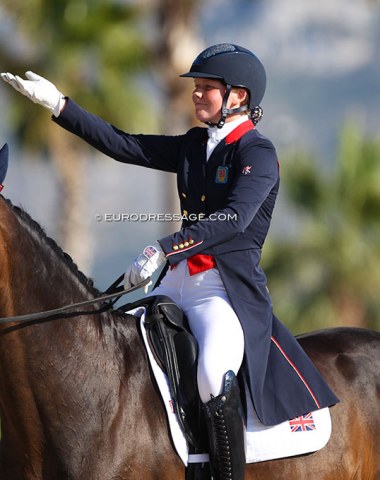 Britain's Caitlin Burgess salutes the crowds