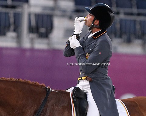 Jose Mena kisses a yellow good luck toy he brought and had tucked in his sleeve