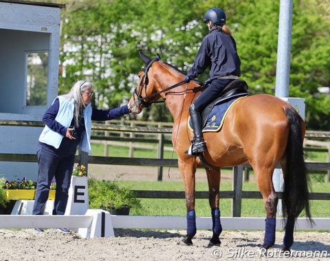 Paralympic bronze medalist Sara Morganti and her second horse Mariebelle who gets a treat from Italian coach Laura Conz.