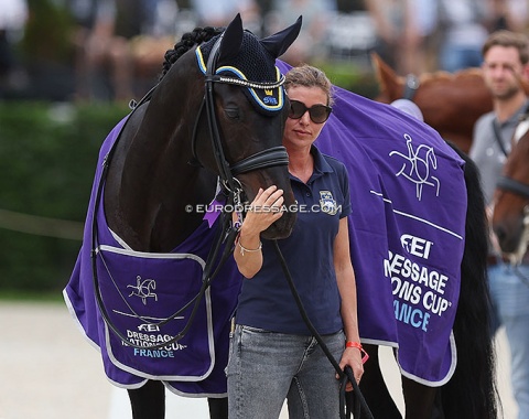 Juliette Ramel's groom cuddles with her horse during the prize giving ceremony