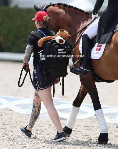 Groom Rikke Kjaer, Vamos Amigos, and Cathrine Dufour's lucky bear "Gerd" in the back pack. She has carried this good luck mascot with her since her pony days