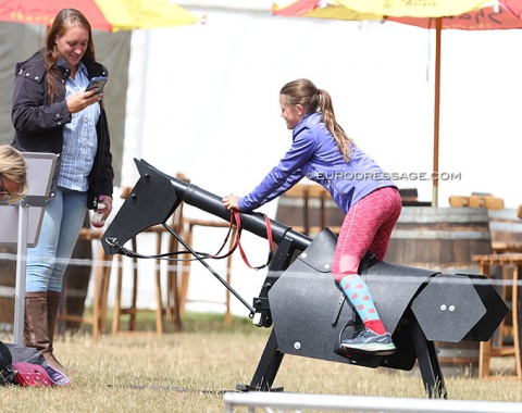 Kid having fun on a race horse dummy