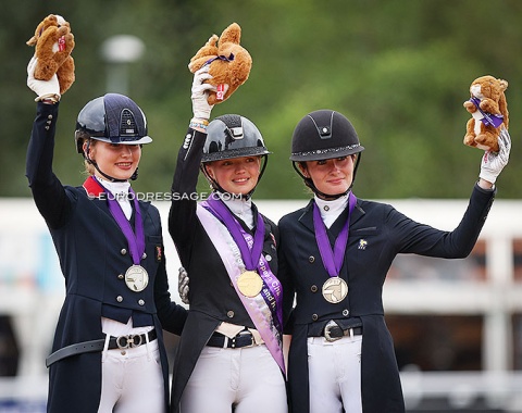 The Kur medallists waving Cyril the Squirrel, the Official Mascot of the European Championships, in the air