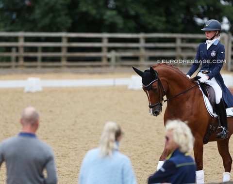 Laura Laustsen warming up Fairy Tale with her parents Bjarke and Patricia and coach watching