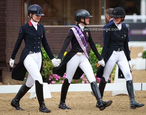 The junior kur medallists marching to the podium: Pidgley, Obel, Juglaret