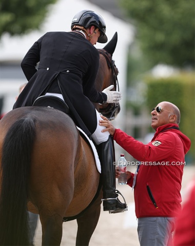 Isabell Werth getting an immediate debrief from co-team trainer Jonny Hilberath after her freestyle at the 2023 CDIO Aachen