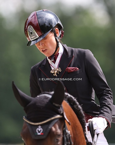 Morales wears a big horse shaped pendant as part of her show gear