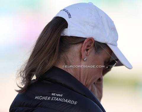 The cap says "Follow the Leaders" the jacket says "we have higher standards"