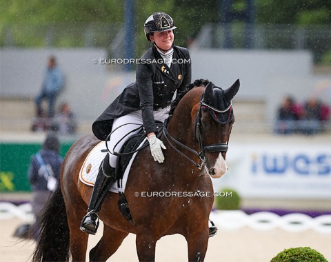 Belgian Laurence Roos pats Fil Rouge who is doing his retirement show here in Aachen