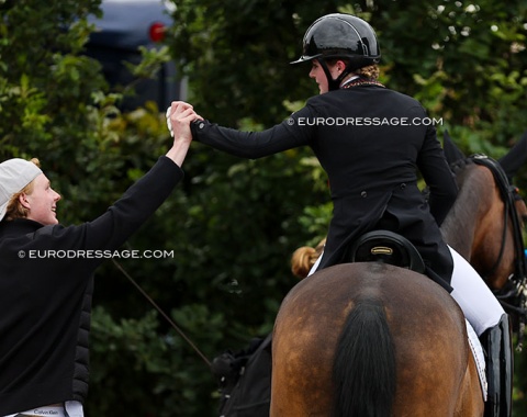 Rose Oatley high-fives with her brother Oskar Oatley