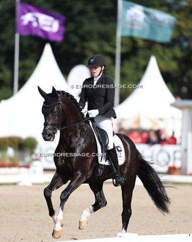Flore de Winne on Eleven HW. The FEI and WBFSH flag flying
