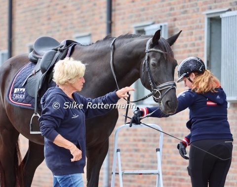 It takes a village: Julia Sciancalepore about to mount Heinrich, with Austrian chef d’equipe Dr. Eva-Maria Bachinger holding the horse