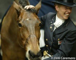 Anky untacks Bonfire together with her groom and gives him a rewarding pat