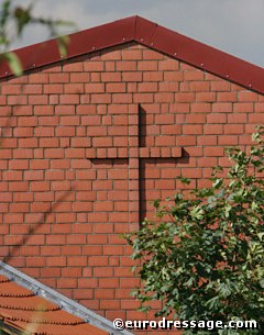 A cross in bricks. God protect this barn