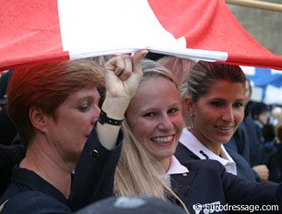 Victoria Max Theurer and her Austrian team mates shelter under their country's flag