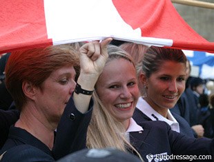 Victoria Max Theurer and her Austrian team mates shelter under their country's flag