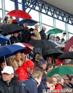 Even the audience had to open umbrella's under the covered bleachers because the rain came down so hard.