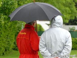 Rain rain go away! Jan Bemelmans wearing the Spanish team coat and covering from the rain.